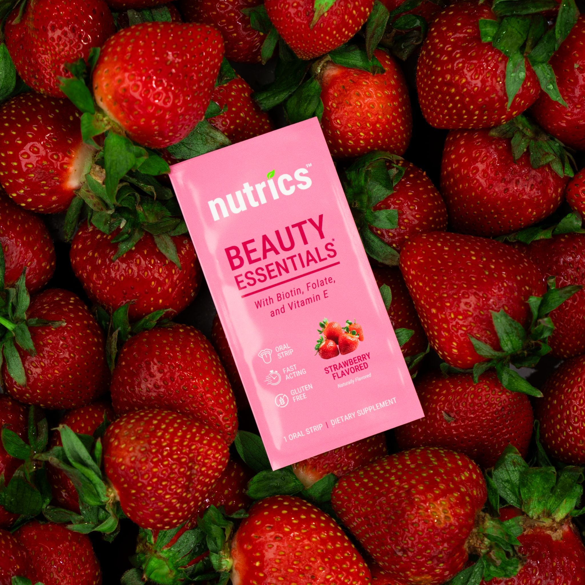 Pink Nutrics Beauty Essentials supplement package surrounded by strawberries