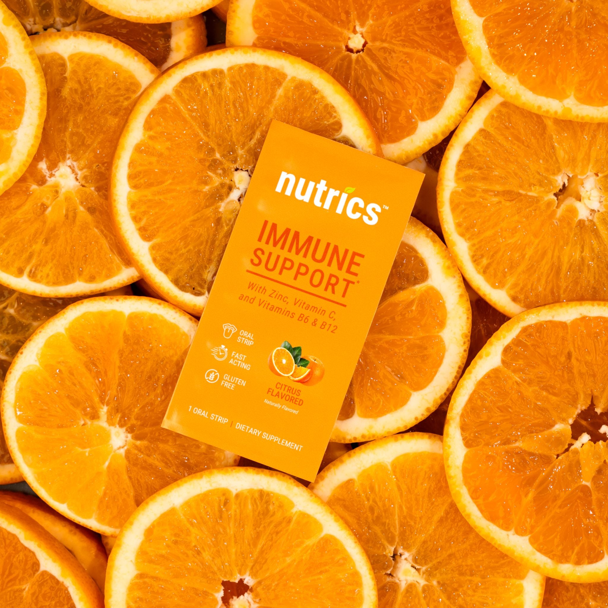 Nutrics immune support supplement package on a background of sliced oranges