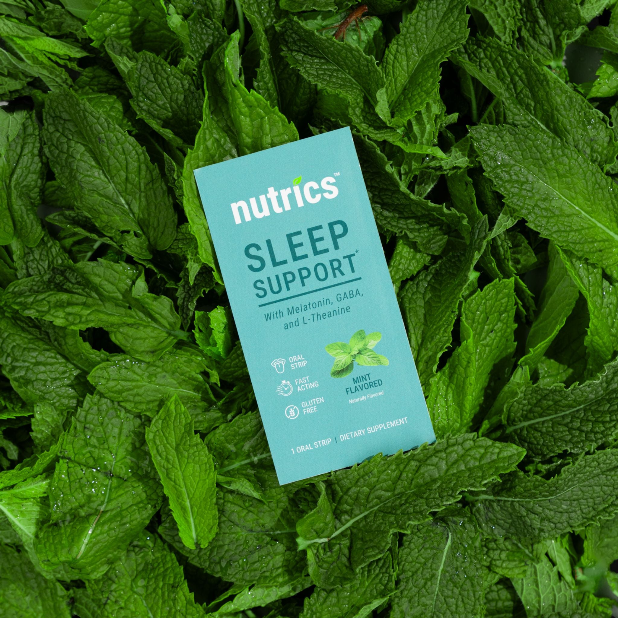Nutrics Sleep Support package on a bed of green leaves